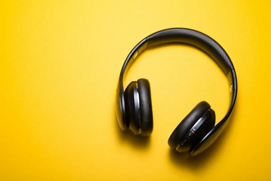 Black headphones on a yellow background (illustrative stock photo)