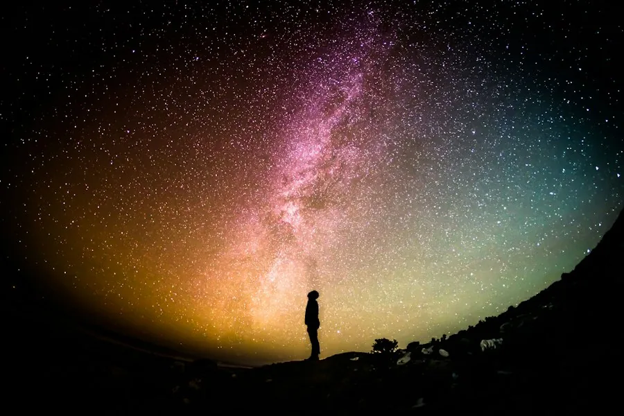 Person standing beneath the Milky Way (illustrative stock photo)